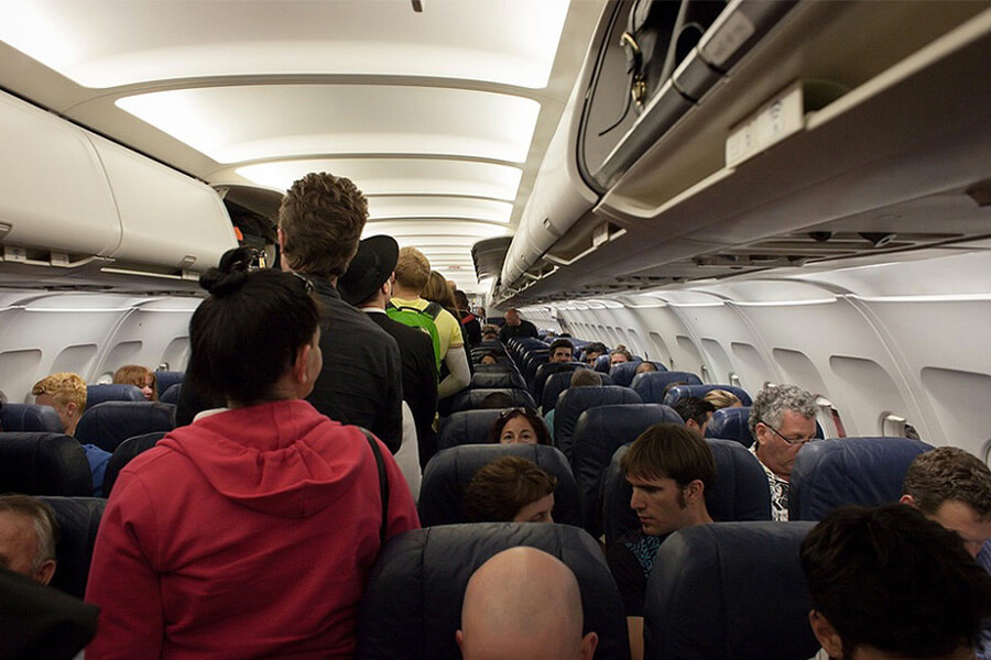 airplane carry on bins and passengers