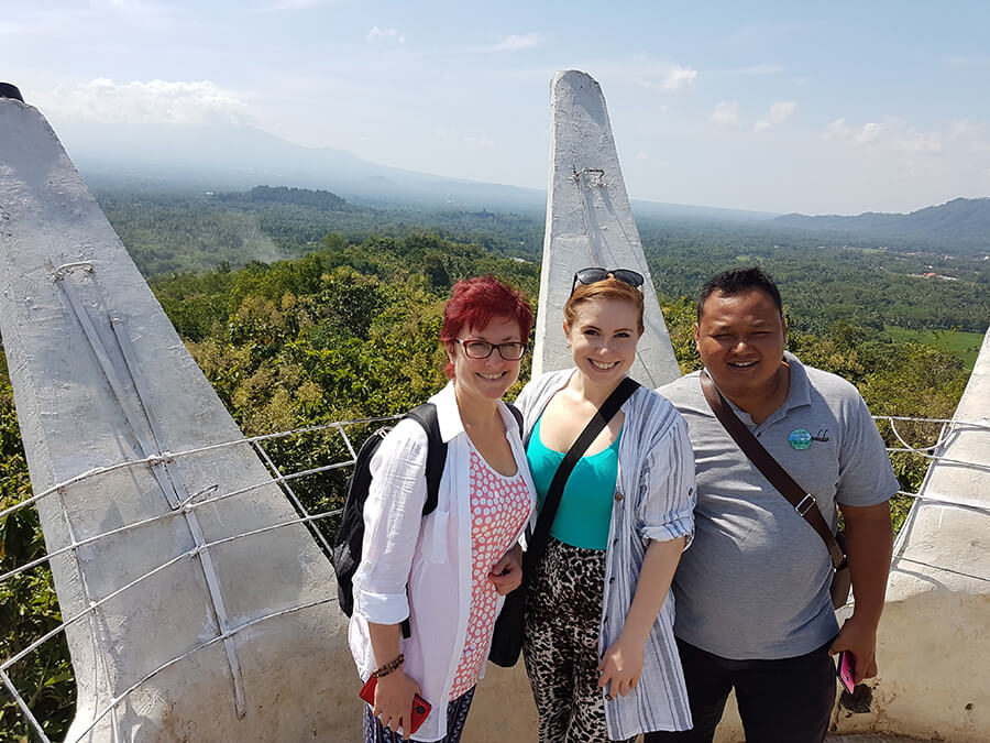 two women one man at borobudur buddhist temple in indonesia